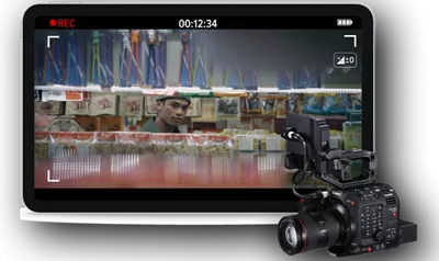 monitor with still frame of man looking through a store aisle and a cinema camera in foreground